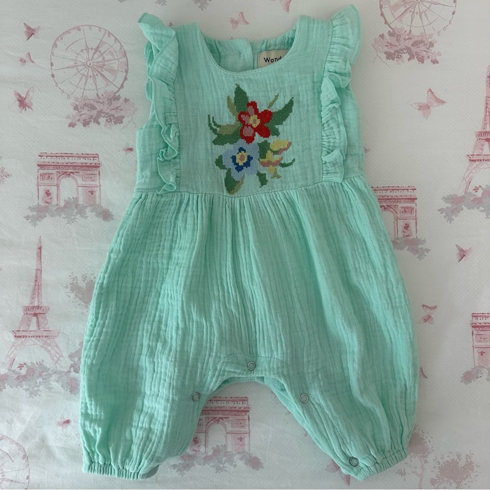 Adorable one piece romper with needlepoint floral detail